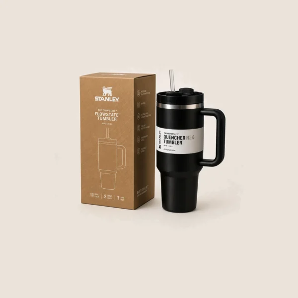 Black insulated steel tumbler with a handle and straw lid beside its box