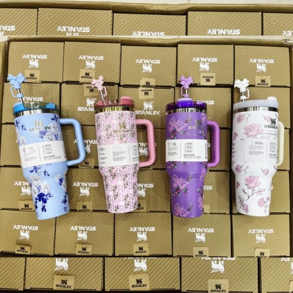 Floral tumblers with handles lined up on packing boxes