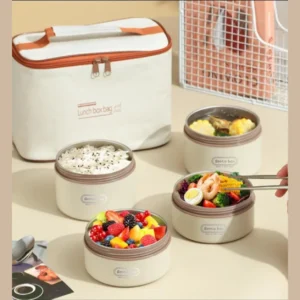 Cream insulated lunch bag with three round food containers holding rice, salad and fruit
