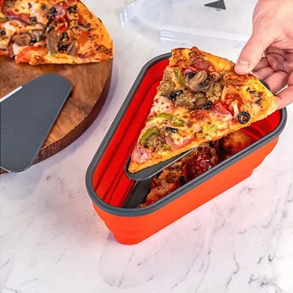 Pizza slice placed in a collapsible pizza storage container on a marble counter