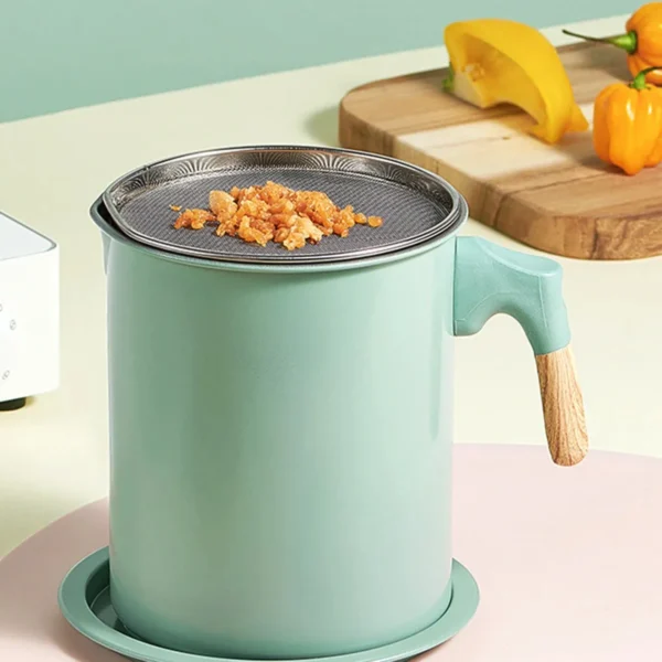 Oil pot with filter in place and crumbs on the mesh beside chopped peppers