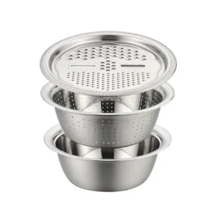 Stacked stainless steel grater lid, colander and mixing bowl on white background