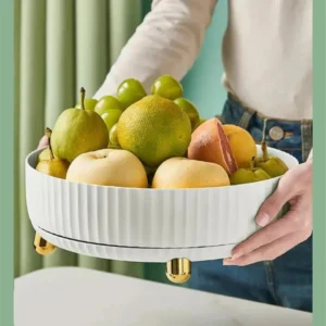 Hand lifting the white rotating tray filled with fruit