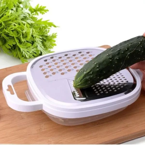 Grating a cucumber on the 4-in-1 vegetable grater set over the storage tray