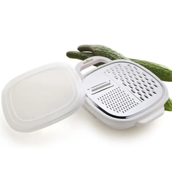4-in-1 vegetable grater tray opened with the lid set beside it and a cucumber