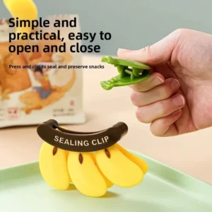 Hand pressing a green banana sealing clip from a yellow bunch on a snack packet