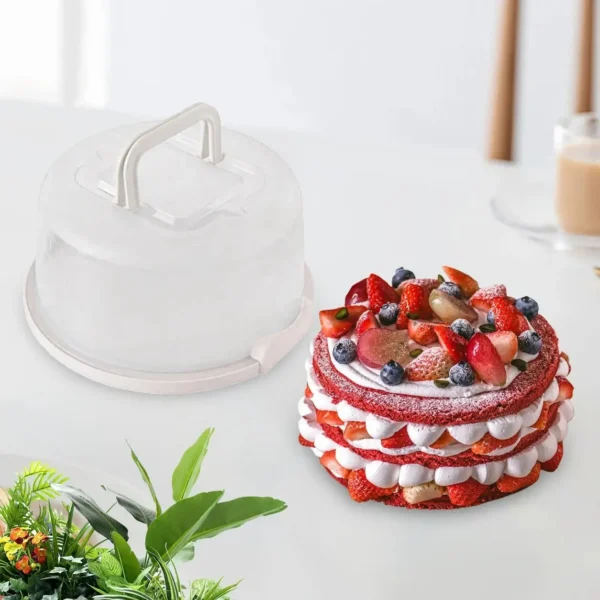 Clear dome cake carrier beside a decorated strawberry layer cake