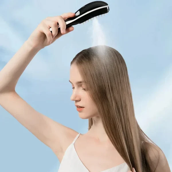 Woman spraying a fine mist on her long hair with the electric scalp massage comb