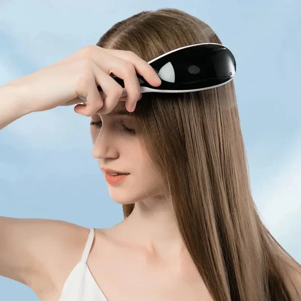Woman combing her hair roots with the electric scalp massage comb