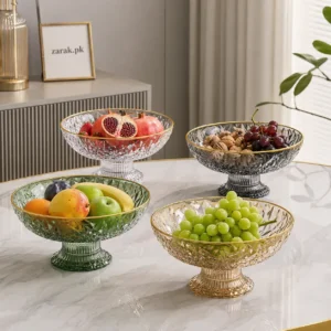 Four faceted acrylic fruit bowls in green, amber, clear and smoke filled with fruit and nuts