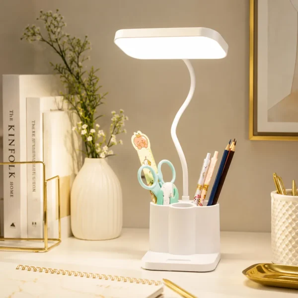 White LED desk lamp with flexible arm and pen holder base holding pens and scissors