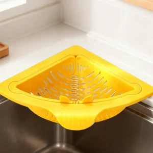 Cream and yellow triangular corner sink baskets in use, one shown being opened by hand