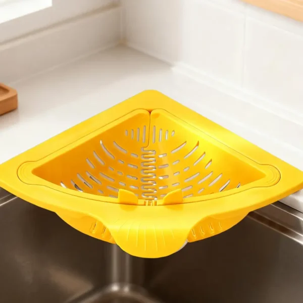 Cream and yellow triangular corner sink baskets in use, one shown being opened by hand
