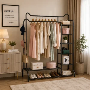 Black metal clothes stand with hanging rail, 4-tier side shelves and shoe shelf in a bedroom