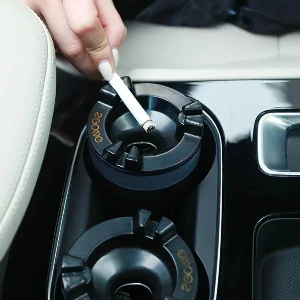 Hand placing a cigarette into the ashtray sitting in a car cup holder