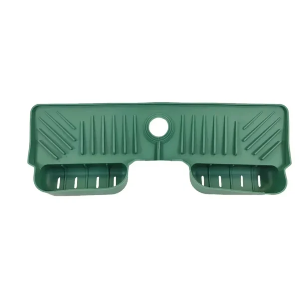 Green silicone faucet tray with a round faucet opening and drain slits in the two baskets