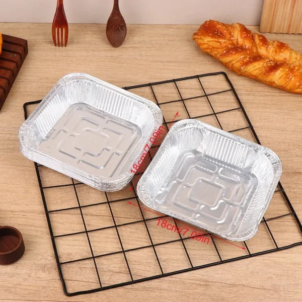 Two square foil plates on a wire rack
