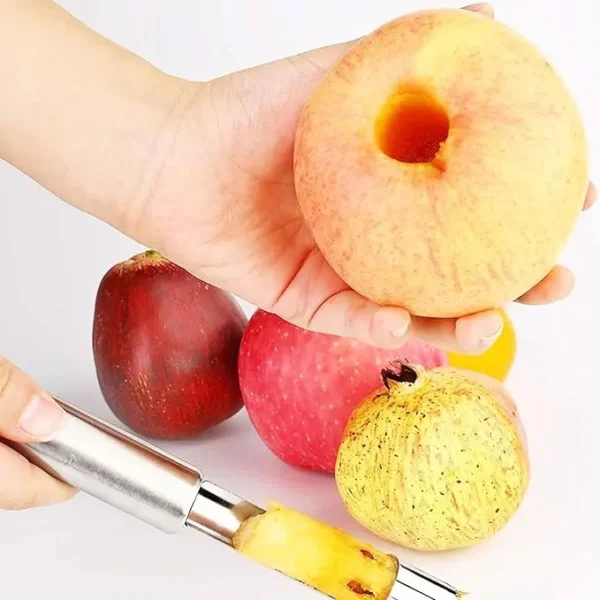 Apple core being removed with a corer, other fruits in the background