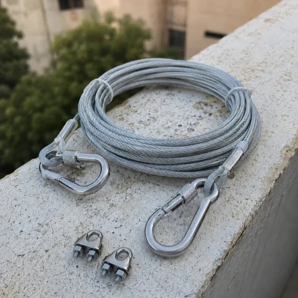 Stainless steel clothesline rope with two screw hooks and wire clamps on a ledge