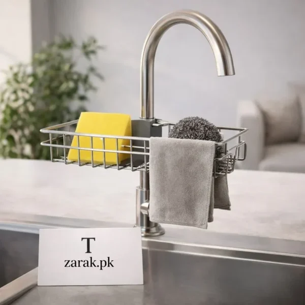 Stainless steel faucet rack holding a yellow sponge, scrubber and cloth on a kitchen tap