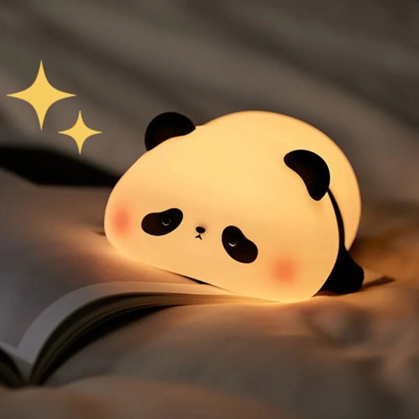 Cute panda LED night lamp glowing on a bedside table