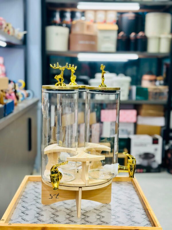 3-in-1 revolving beverage dispenser with gold taps on a wooden stand